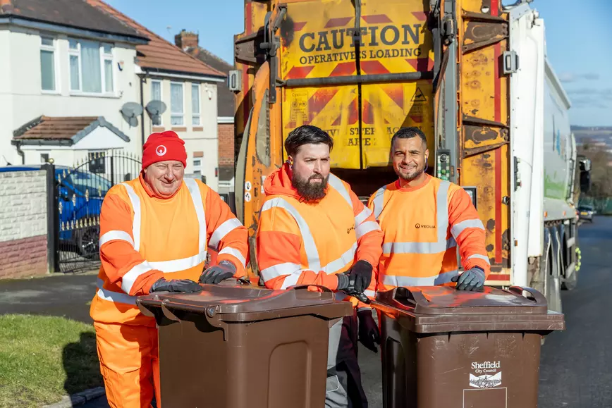 Three bin collectors smiling with brown bins